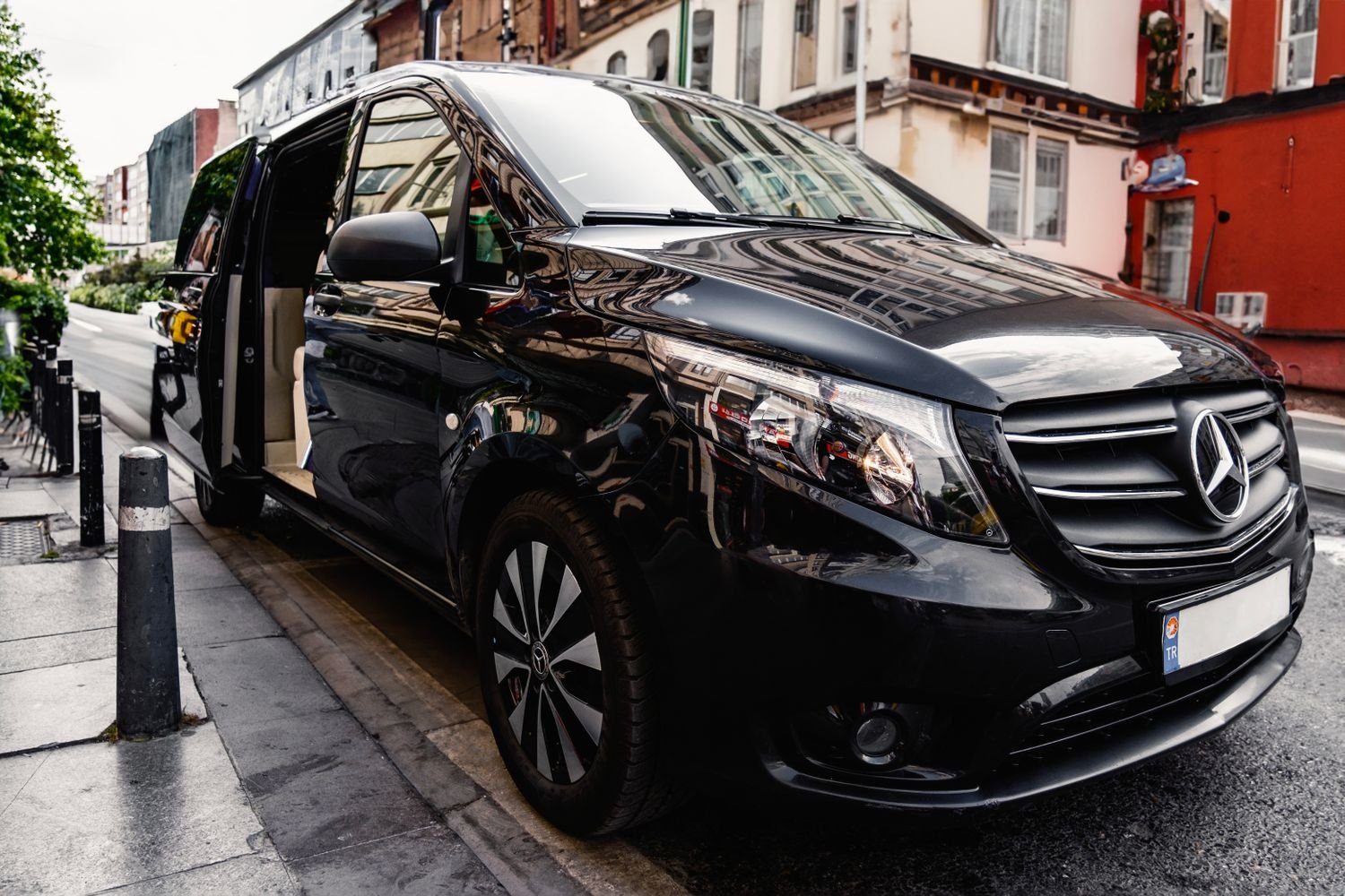 Black Mercedes-Benz V-Class van with the side door open
